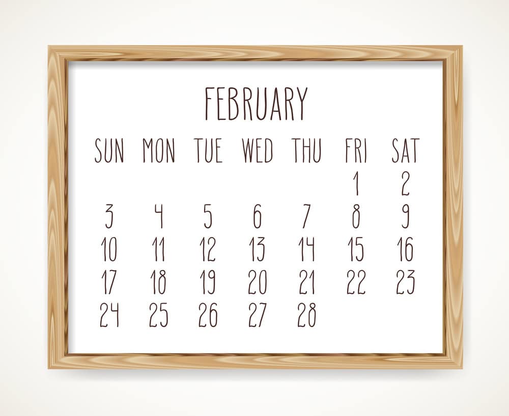 a wall calendar with a wooden frame