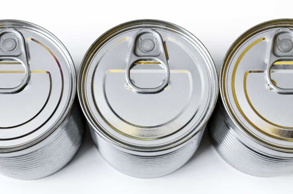 detail of the lids of three cans of conserved food