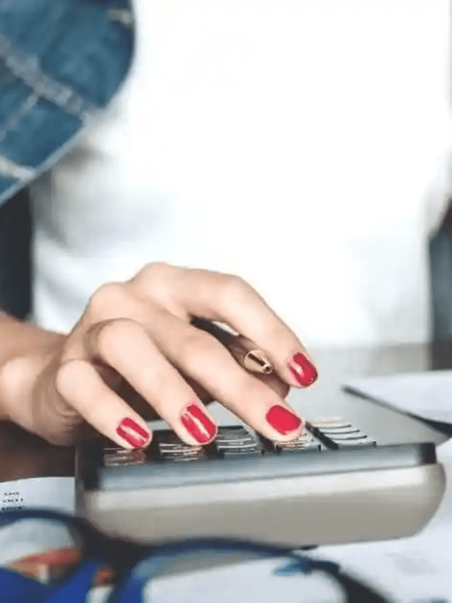 women typing on calculator