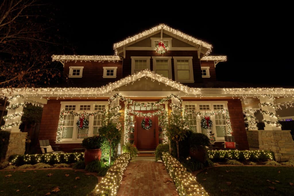 house decorated for christmas with christmas lights at night time