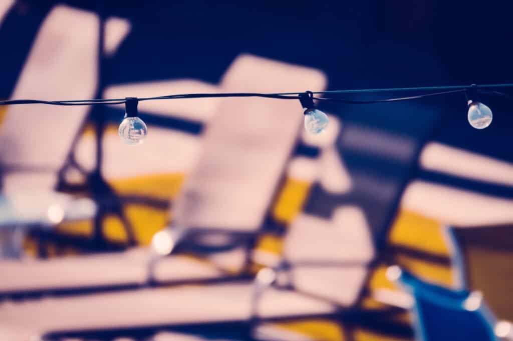 Retro Style Background Inage of String Party Lights on a Pool Deck at a Vintage Motel