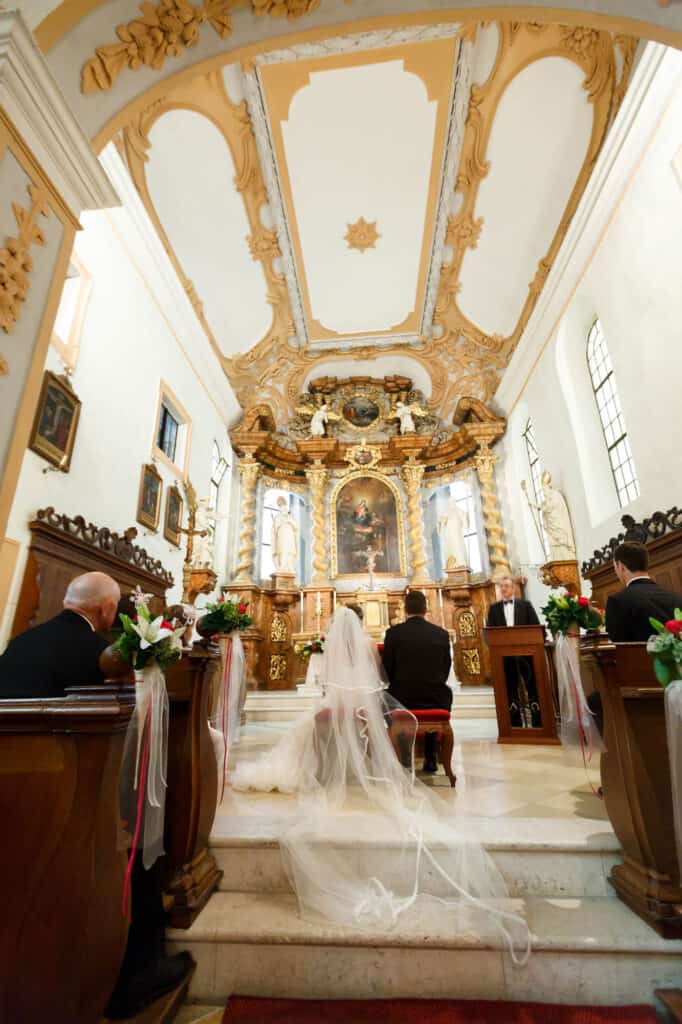 elegant stylish cute groom and bride  on the background old gothic church