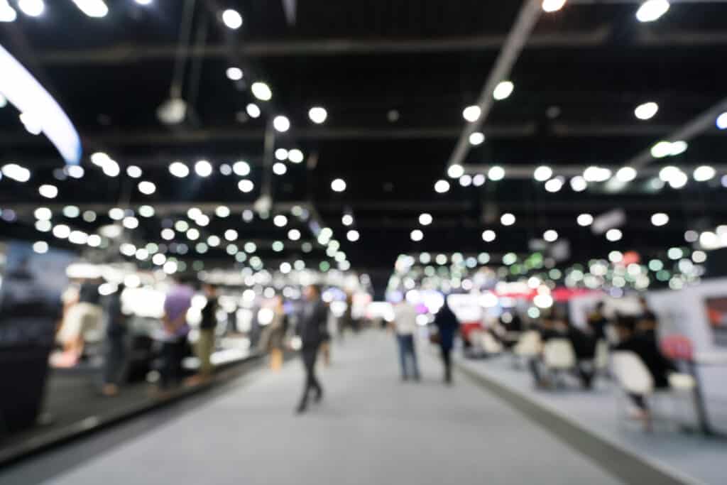 Blur, defocused background of public exhibition hall. Business tradeshow, job fair, or stock market. Organization or company event, commercial trading, or shopping mall marketing advertisement concept