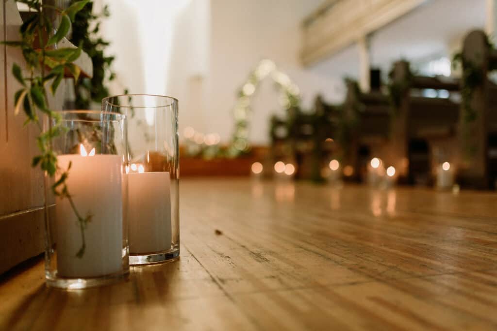 Details of the wedding day. Church Wedding decorations with plants and candles. Fine film grain texture.