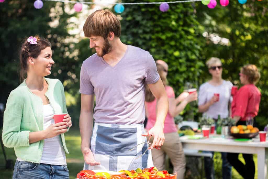 couple standing together at a backyard bbq