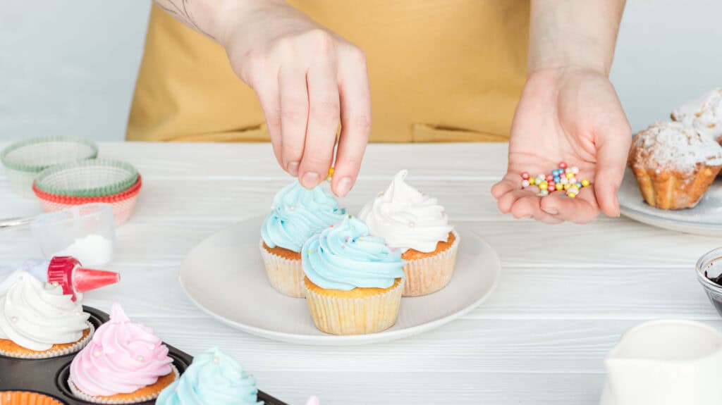 decorating cupcakes on a plate